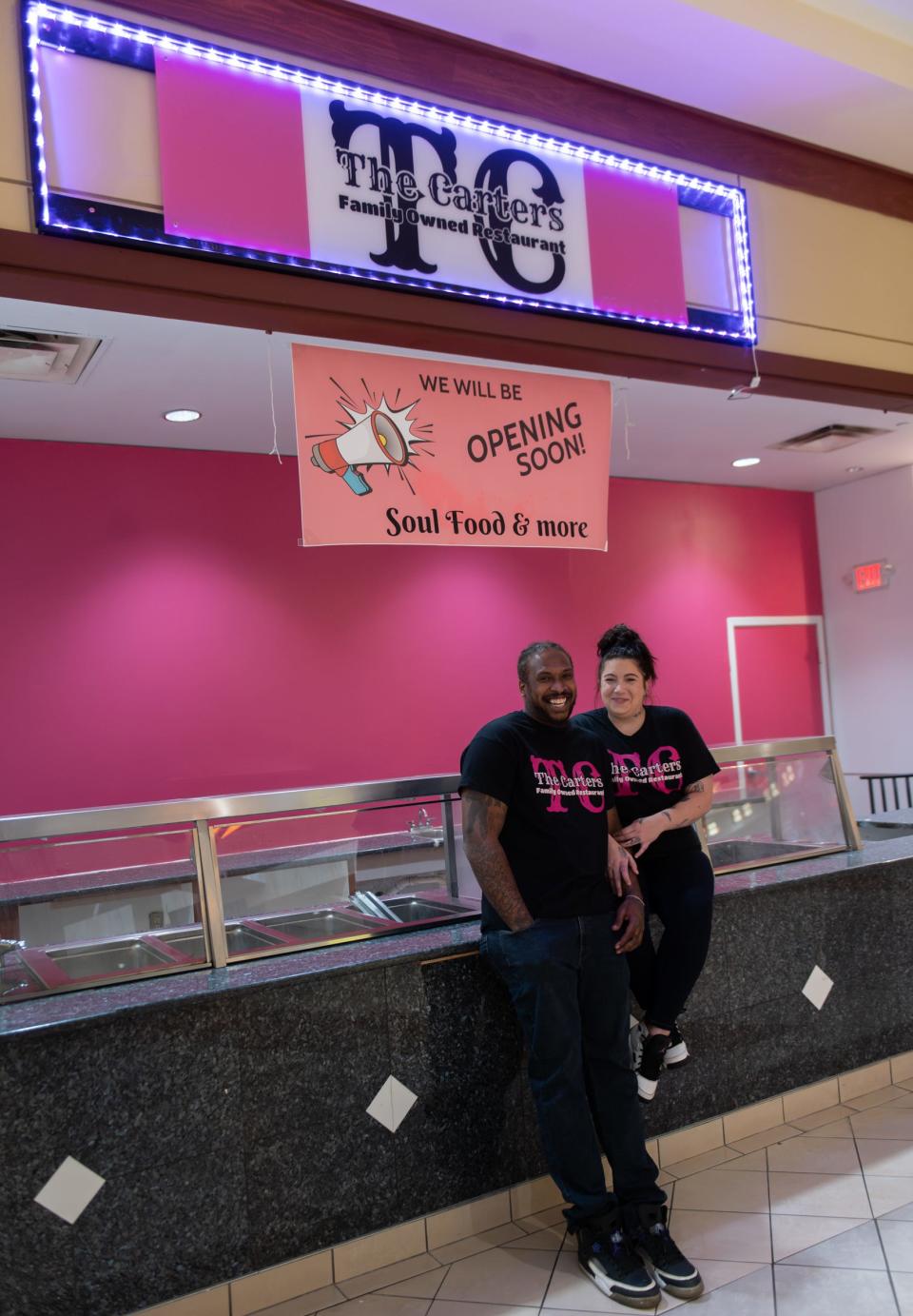 Eldred and Kameron Carter of The Carters Family Owned Restaurant pose for a portrait at their forthcoming restaurant in the Lansing Mall Food Court, Monday, Dec. 4, 2023. It opened earlier this month.