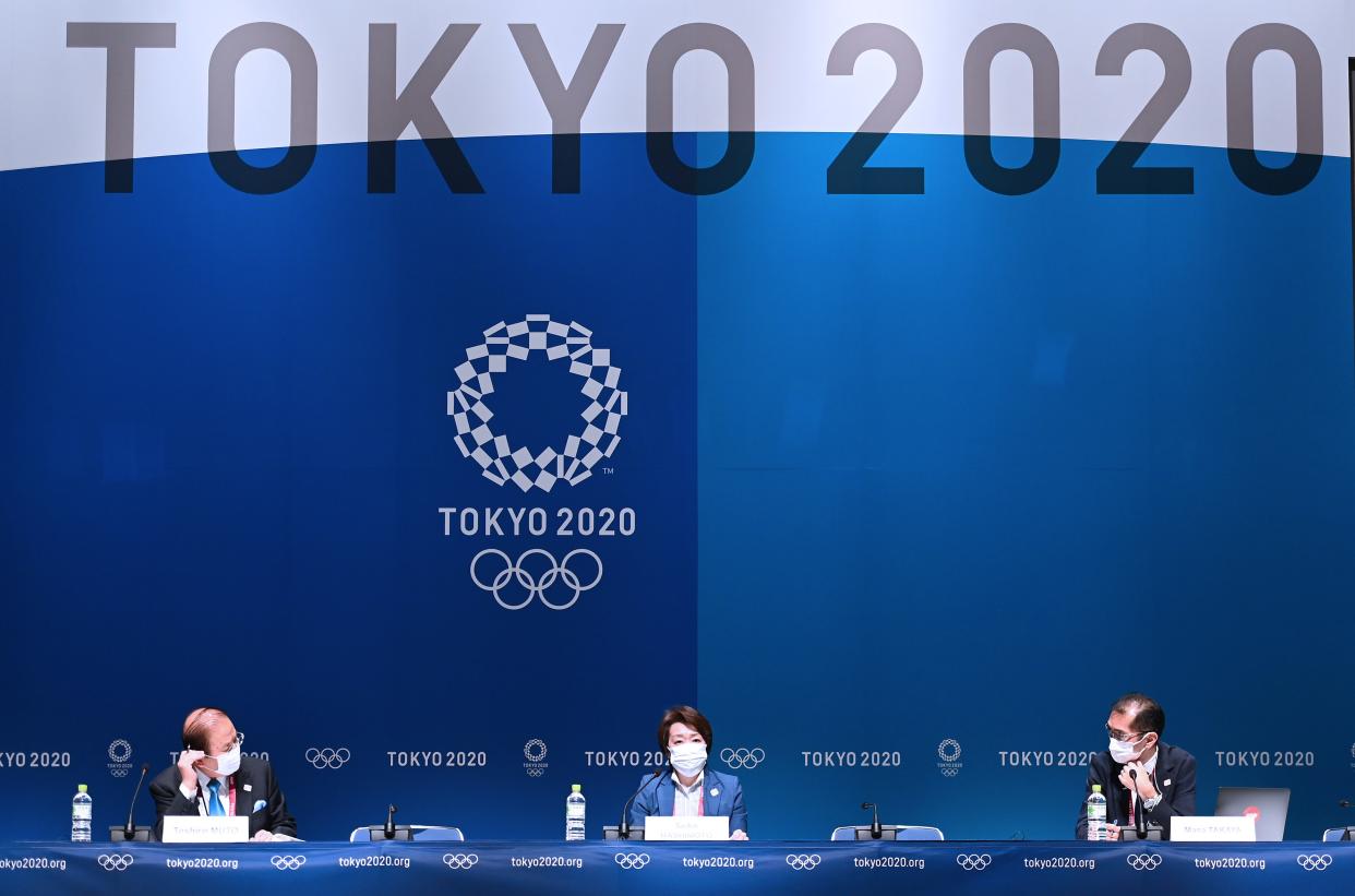 Toshiro Muto (left), head of the Tokyo Olympics organizing committee, didn't rule out canceling the Games even at this super-late stage. (Photo by He Changshan/Xinhua via Getty Images)