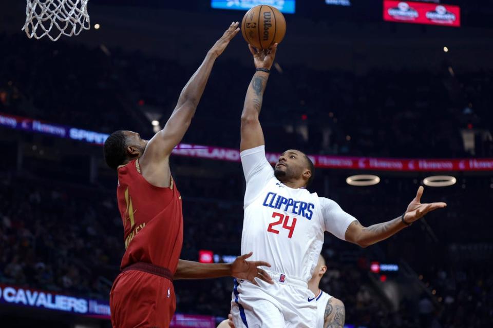 Los Angeles Clippers guard Norman Powell (24) shoots against Cleveland Cavaliers forward Evan Mobley (4) during the first half of an NBA basketball game, Monday, Jan. 29, 2024, in Cleveland. (AP Photo/Ron Schwane)