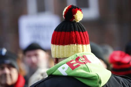 A man wears a hat in German flag colors as he attends a demonstration against migrants in Cottbus, Germany February 3, 2018. REUTERS/Hannibal Hanschke