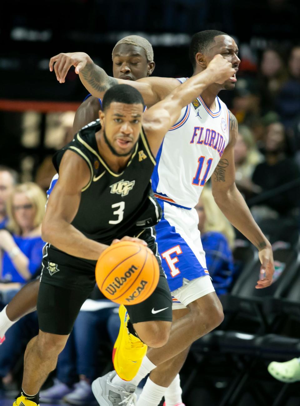 UCF Knights guard Darius Johnson (3) steals the ball from Florida Gators guard Kyle Lofton (11) during the first half of the NIT tournament Wednesday, March 15, 2023, at Exactech Arena in Gainesville, Fla. Alan Youngblood/Gainesville Sun 