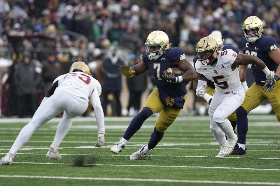 Notre Dame running back Audric Estime (7) runs past Boston College's Cole Batson (23) during the first half of an NCAA college football game, Saturday, Nov. 19, 2022, in South Bend, Ind. (AP Photo/Darron Cummings)