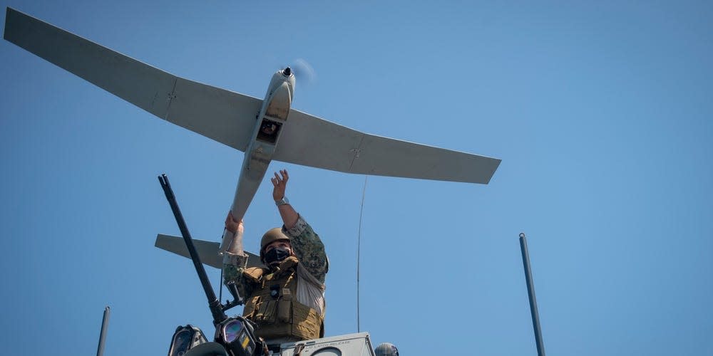 Intelligence Specialist 2nd Class Jimenez Gerardo, assigned to Commander Task Force 56, launches an RQ-20B PUMA Unmanned Aerial System aboard a Mark VI Patrol Boat in the Arabian Gulf, April 16.