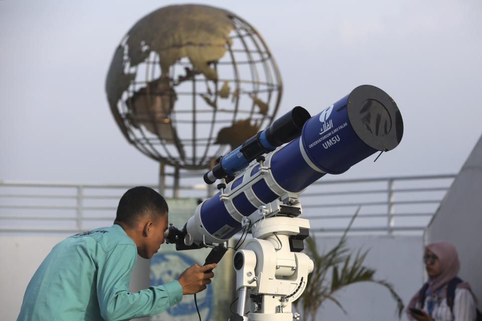 A member of staff uses a telescope to search the sky for the new moon that signals the start of the Islamic holy fasting month of Ramadan, at the Astronomical Observatory of the Muhammadiyah University of North Sumatra in Medan, Indonesia, Sunday, March 10, 2024. People in the world's most populous Muslim country will start observing Ramadan, the holiest month in Islamic calendar on March 12. (AP Photo/Binsar Bakkara)