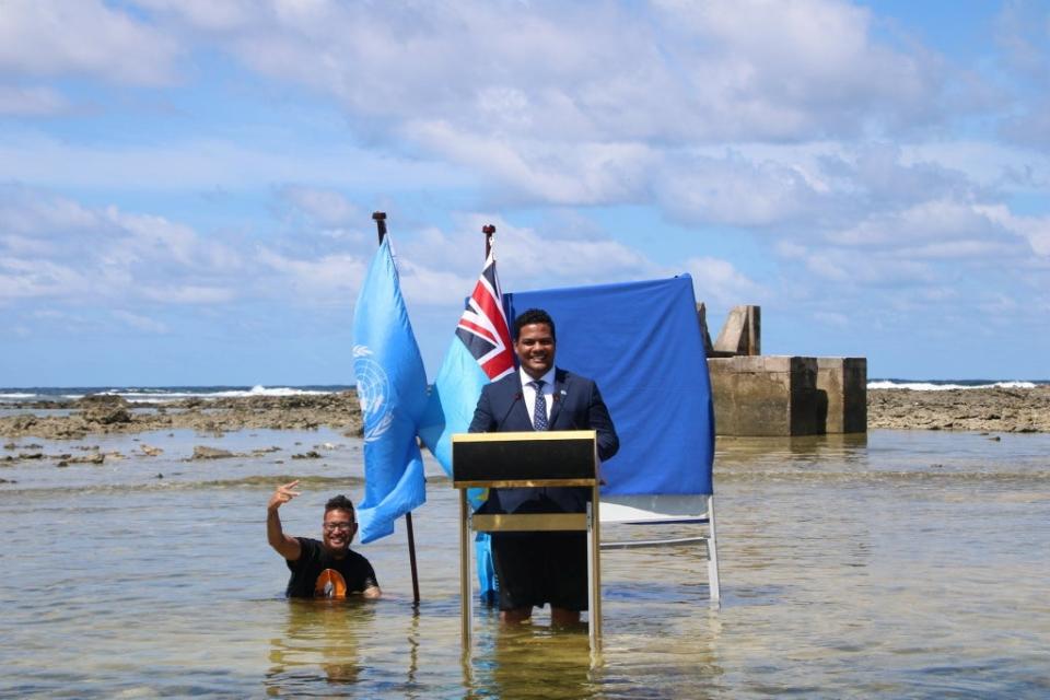 Tuvalu's Minister for Justice, Communication & Foreign Affairs Simon Kofe gives a COP26 statement while standing in the ocean (via REUTERS)