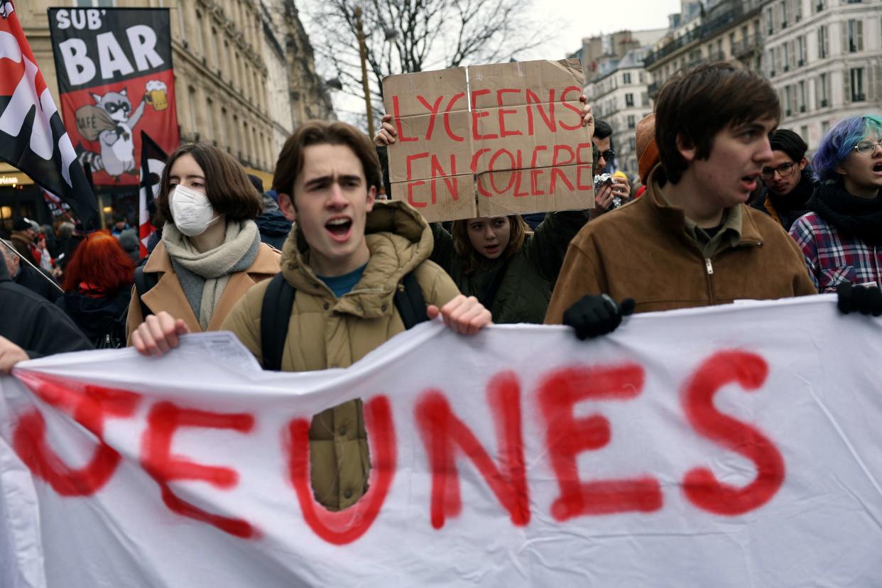 Protesters hold a banner reading 