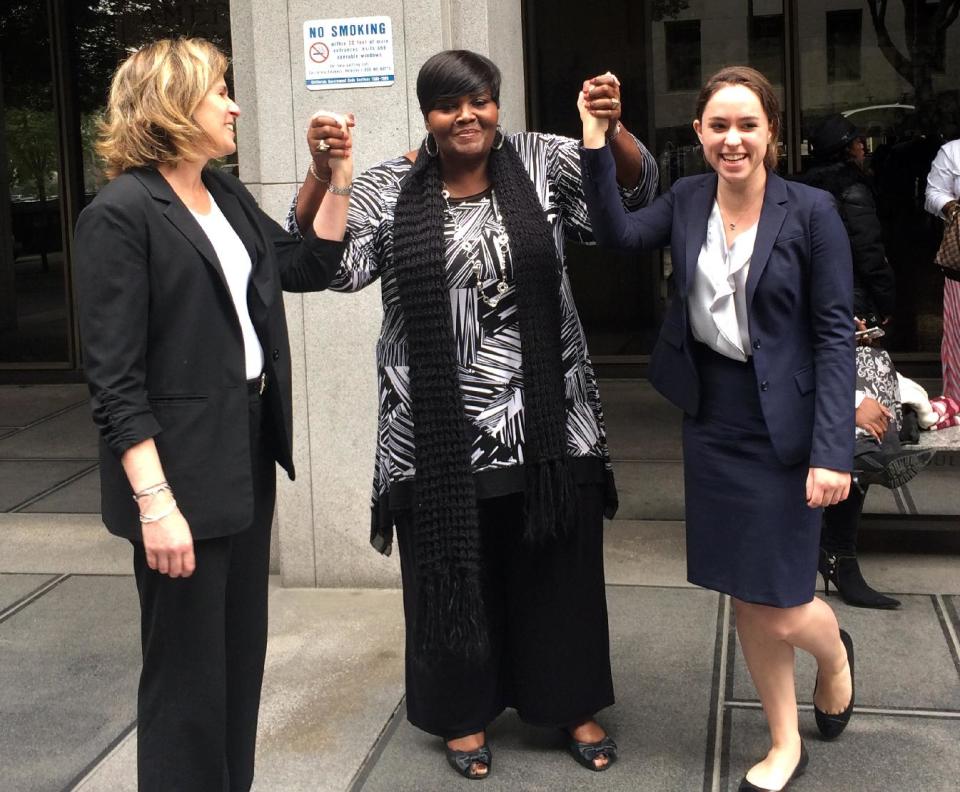 In this photo taken on Monday, March 24, 2014 and released by the University of Southern California Gould School of Law, USC Post-Conviction Justice Project attorneys, Heidi Rummel, left, and Laura Donaldson, right, celebrate with Mary Virginia Jones' daughter, Denitra Jones-Goodie, outside Superior court in Los Angeles. Mary Virginia Jones, a 74-year-old California woman, was freed late Monday after serving 32 years of a life sentence for her role in a 1981 killing. Los Angeles County prosecutors conducted a new investigation and agreed to accept a plea of no contest for involuntary manslaughter. Judge William C. Ryan ruled Monday afternoon that Jones had served well over the 11-year maximum sentence for the lesser crime and ordered her freed. (AP Photo/USC Gould School of Law, Jilien Silsby)