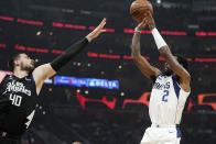 Dallas Mavericks guard Kyrie Irving, right, shoots as Los Angeles Clippers center Ivica Zubac defends during the first half of an NBA basketball game Wednesday, Feb. 8, 2023, in Los Angeles. (AP Photo/Mark J. Terrill)