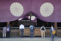 Worshippers bow while visiting Yasukuni Shrine in Tokyo, Wednesday, April 21, 2021, the first day of the annual Spring Rites, the Shinto shrine’s biannual festival honoring the war dead. (AP Photo/Koji Sasahara)