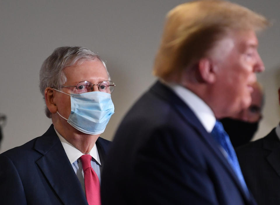 Senate Majority Leader Mitch McConnell, a Republican from Kentucky, wears a protective mask as U.S. President Donald Trump speaks to members of the media following the weekly Senate Republican caucus luncheon at the Hart Senate Office Building in Washington, D.C., U.S., on Tuesday, May 19, 2020. (Kevin Dietsch/UPI/Bloomberg via Getty Images)