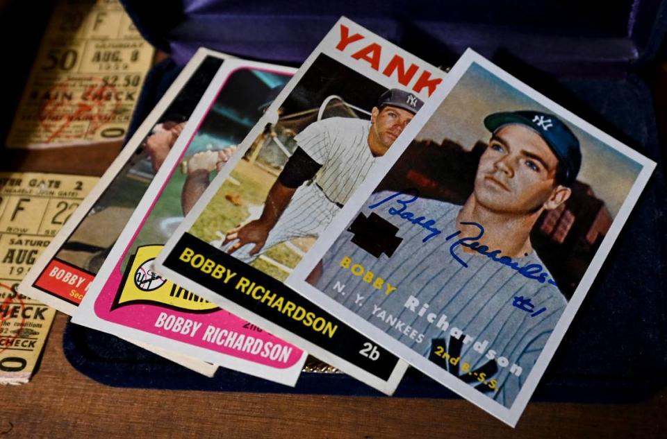 Baseball cards showing New York Yankees second baseman Bobby Richardson sit on a shelf in his home office.