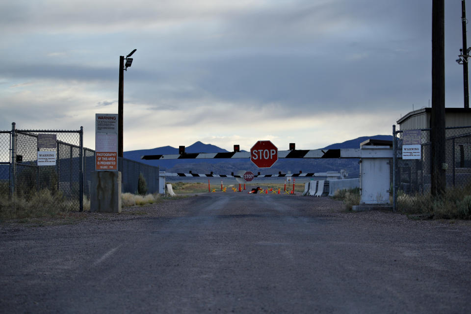 In this July 22, 2019 photo, signs warn about trespassing at an entrance to the Nevada Test and Training Range near Area 51 outside of Rachel, Nev. The U.S. Air Force has warned people against participating in an internet joke suggesting a large crowd of people "storm Area 51," the top-secret Cold War test site in the Nevada desert. (AP Photo/John Locher)