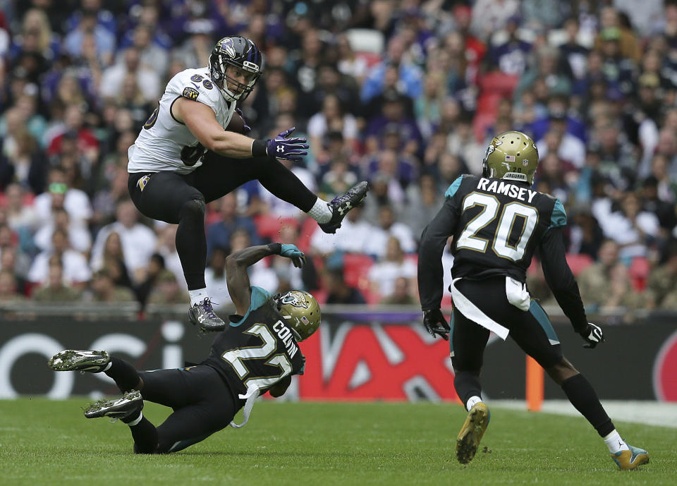 <p>Baltimore Ravens tight end Nick Boyle (86) leaps above Jacksonville Jaguars cornerback Aaron Colvin (22) during the second half of an NFL football game at Wembley Stadium in London, Sunday Sept. 24, 2017. (AP Photo/Tim Ireland) </p>