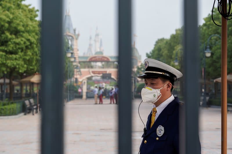 A security guard wears a face mask at Shanghai Disney Resort as the Shanghai Disneyland theme park reopens following a shutdown due to the coronavirus disease (COVID-19) outbreak, in Shanghai