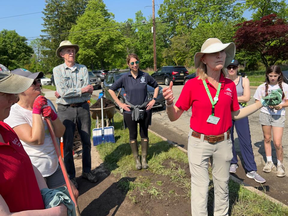 Catherine Pariser, of Wayne, a Rutgers-certified master gardener who organized the project, gives instructions to the volunteers.