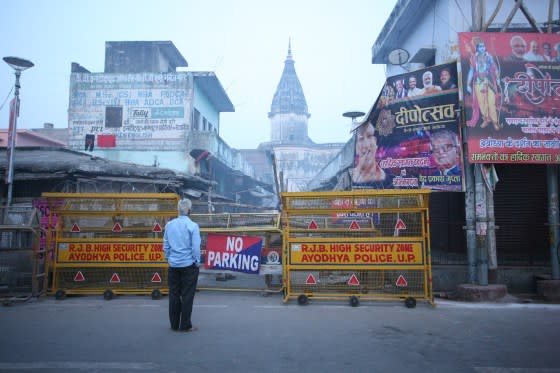 A local man looks on through barricade on street near Hanmuna Gadhi temple in Ayodhya on Nov. 9, 2019, ahead of a Supreme Court verdict on the future of the Ram Temple. <span class="copyright">Ritesh Shukla—NurPhoto/Getty Images</span>