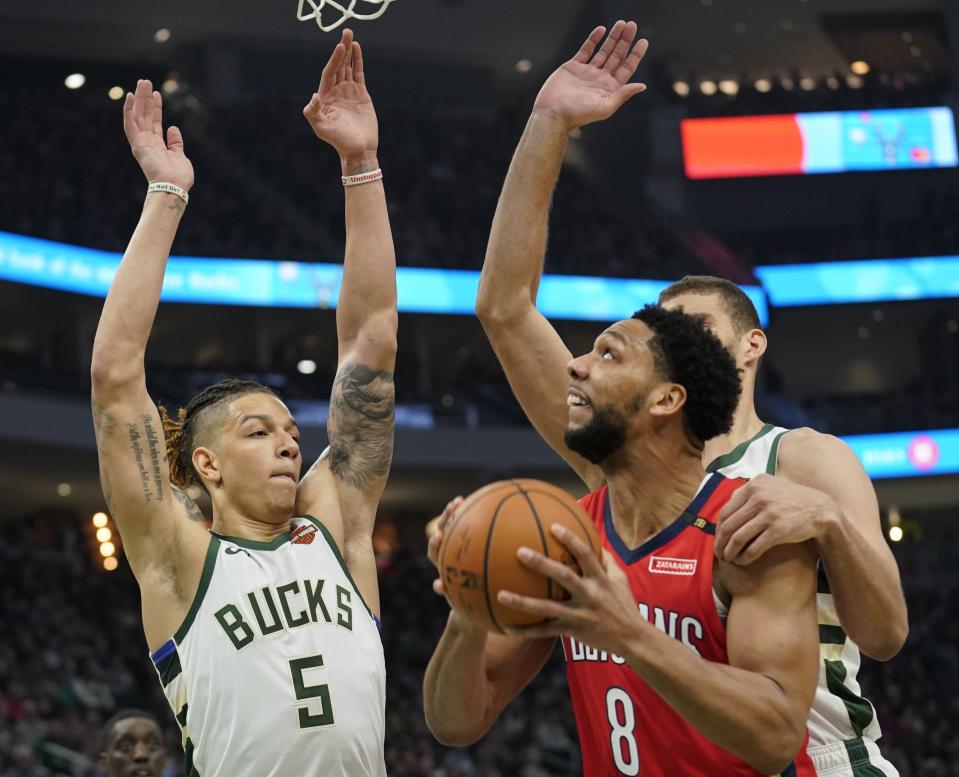 New Orleans Pelicans' Jahlil Okafor is fouled by Milwaukee Bucks' Brook Lopez as he shoots during the first half of an NBA basketball game Wednesday, Dec. 19, 2018, in Milwaukee. (AP Photo/Morry Gash)