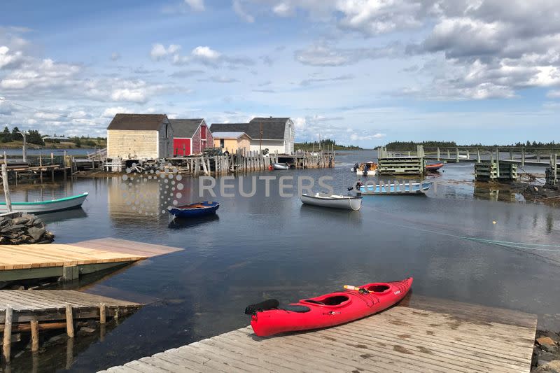 A red kayak is pictured on a dock in Blue Rocks