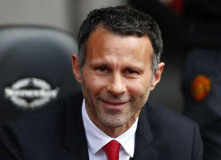 Manchester United's interim manager Ryan Giggs smiles before their English Premier League soccer match against Southampton at St Mary's Stadium in Southampton, southern England May 11, 2014. REUTERS/Andrew Winning