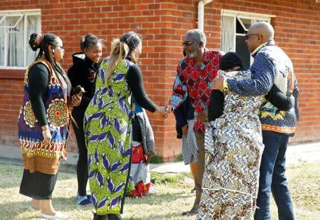 Former Zimbabwe President Robert Mugabe's nephews, Leo Mugabe and Philip Chiyangwa, are consoled by relatives at their uncle's rural homestead in Kutama