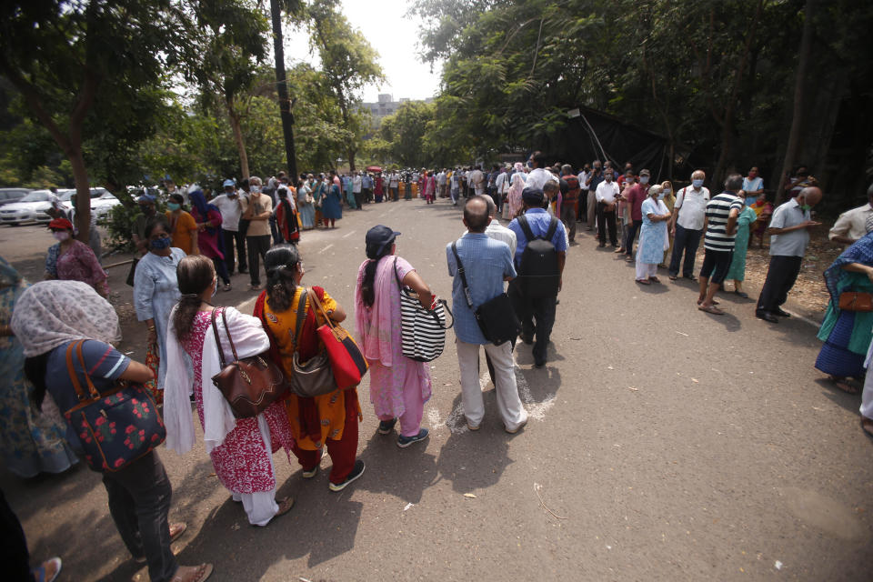 FILE- In this April 26, 2021, file photo, Indians queue up to get vaccinated against the COVID-19 in Mumbai, India. India, the world’s largest maker of vaccines, was expected to play a pivotal role in global efforts to immunize against COVID-19. But its own capacity is proving to be insufficient for its own massive needs amid a ferocious surge of new infections. In past weeks, many people wanting to get vaccines have been turned away. Experts say that this is due to bad planning. (AP Photo/Rafiq Maqbool, File)