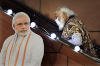 FILE - In this Nov. 11 2020, file photo, Indian Prime Minister Narendra Modi leaves after a function at the Bharatiya Janata Party headquarters following a state election in New Delhi, India. Despite clear signs that India was being swamped by another surge of coronavirus infections, Modi refused to cancel campaign rallies, a major Hindu festival and cricket matches with spectators. The crisis has badly dented Modi’s carefully cultivated image as an able technocrat. (AP Photo/Manish Swarup, File)