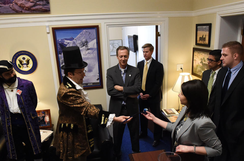 Dressed in colonial garb, Adam Eidinger and fellow D.C. marijuana advocates visit the office staff of Rep. Jason Chaffetz (R-Utah) at the Rayburn House Office Building on Capitol Hill on March 17, 2015, to protest the congressman's stand in regard to legalized marijuana in the District of Columbia. Legislative Director Amber Kirby Talley receives a pipe from Eidinger.