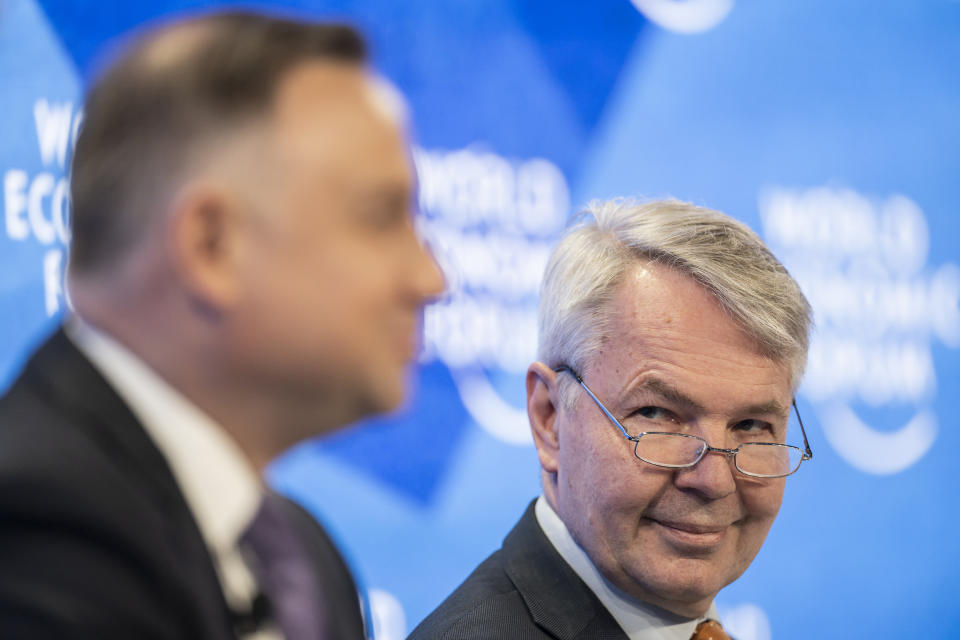 Pekka Haavisto, Minister for Foreign Affairs of Finland of Finland, right, and Andrzej Duda, President of Poland address a panel session during the 51st annual meeting of the World Economic Forum, WEF, in Davos, Switzerland, on Tuesday, May 24, 2022. The forum has been postponed due to the Covid-19 outbreak and was rescheduled to early summer. The meeting brings together entrepreneurs, scientists, corporate and political leaders in Davos under the topic "History at a Turning Point: Government Policies and Business Strategies" from 22 - 26 May 2022. (Gian Ehrenzeller/Keystone via AP)