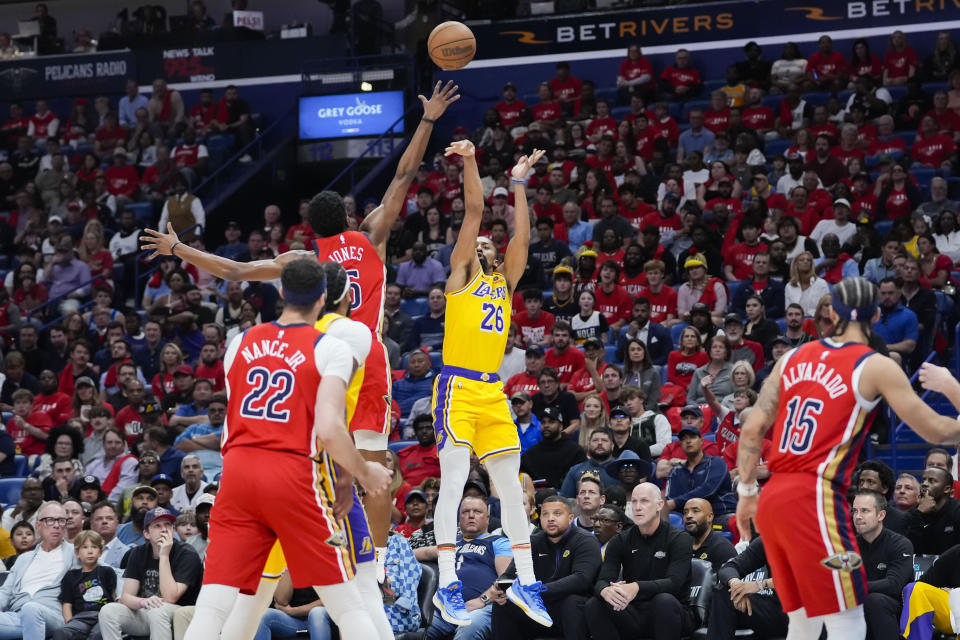 Los Angeles Lakers guard Spencer Dinwiddie (26) shoots against New Orleans Pelicans forward Herbert Jones in the first half of an NBA basketball play-in tournament game Tuesday, April 16, 2024, in New Orleans. (AP Photo/Gerald Herbert)