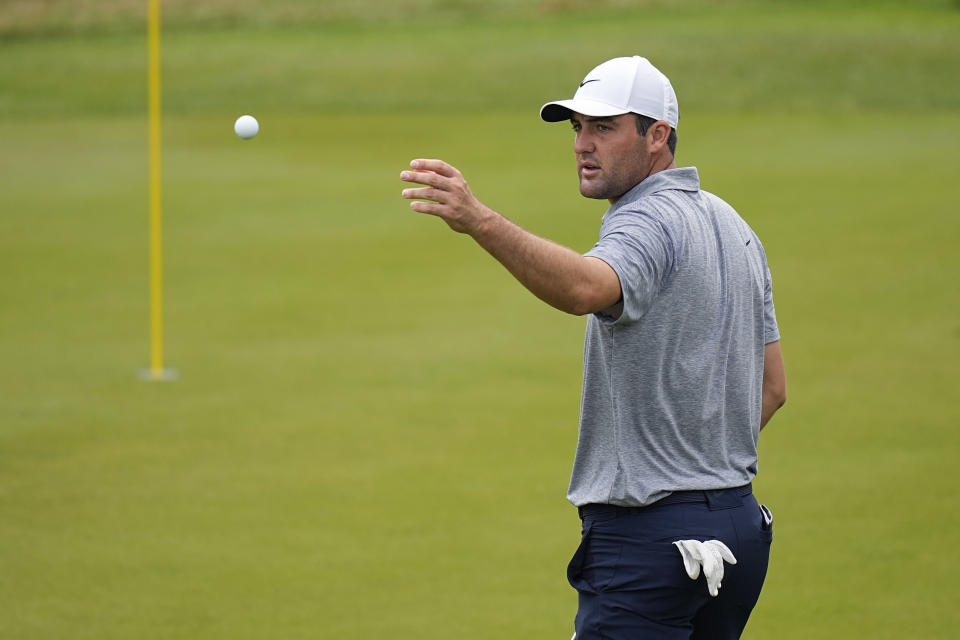 Scottie Scheffler tosses his ball to his caddie on the second green during the third round of the Dell Technologies Match Play Championship golf tournament in Austin, Texas, Friday, March 24, 2023. (AP Photo/Eric Gay)