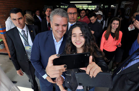 Ivan Duque, presidential candidate of the party Centro Democratico, poses for a photograph after casting his vote during the legislative elections in Bogota, Colombia March 11, 2018. REUTERS/Carlos Julio Martinez