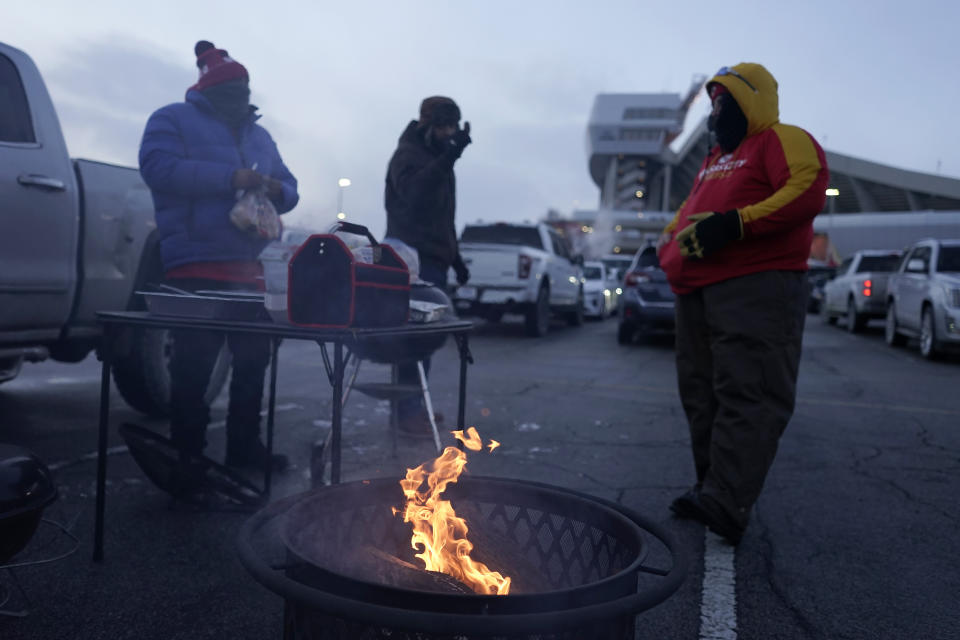 Fans tailgate outside Arrowhead Stadium before an NFL wild-card playoff football game between the Kansas City Chiefs and the Miami Dolphins on Saturday, Jan. 13, 2024, in Kansas City, Mo. (AP Photo/Charlie Riedel)