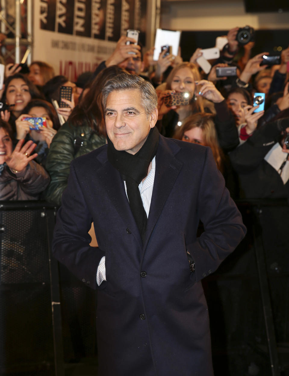 American actor George Clooney poses for photographers on the red carpet for the screening of the movie "Monuments Men ", in Pioltello, near Milan, Italy, Monday, Feb. 10, 2014. (AP Photo/Antonio Calanni)