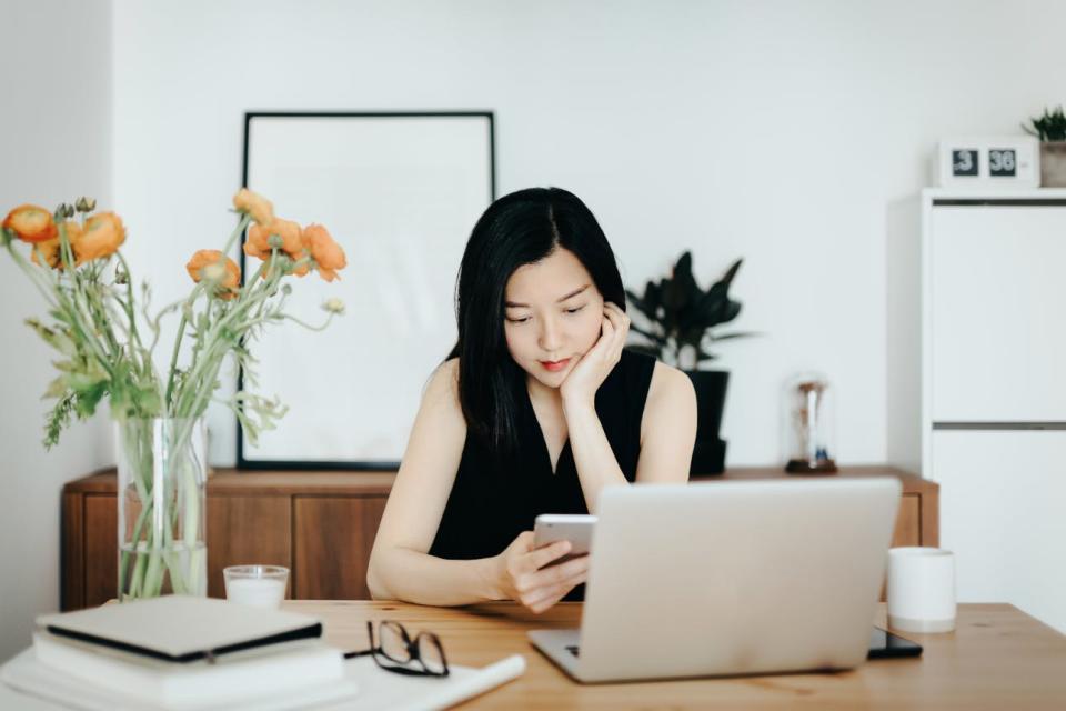 A woman uses a laptop