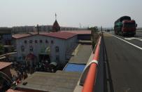 Trucks pass the "underground" Zhongxin Bridge Catholic Church in Tianjin, on May 24, 2014