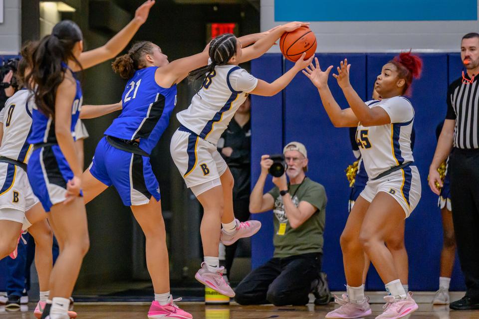 Battle's Tayla Robinson (3) fights for the defensive rebound with Quincy Notre Dame's Jada Brown (21) at Columbia College on Jan. 7, 2024, in Columbia, Mo.