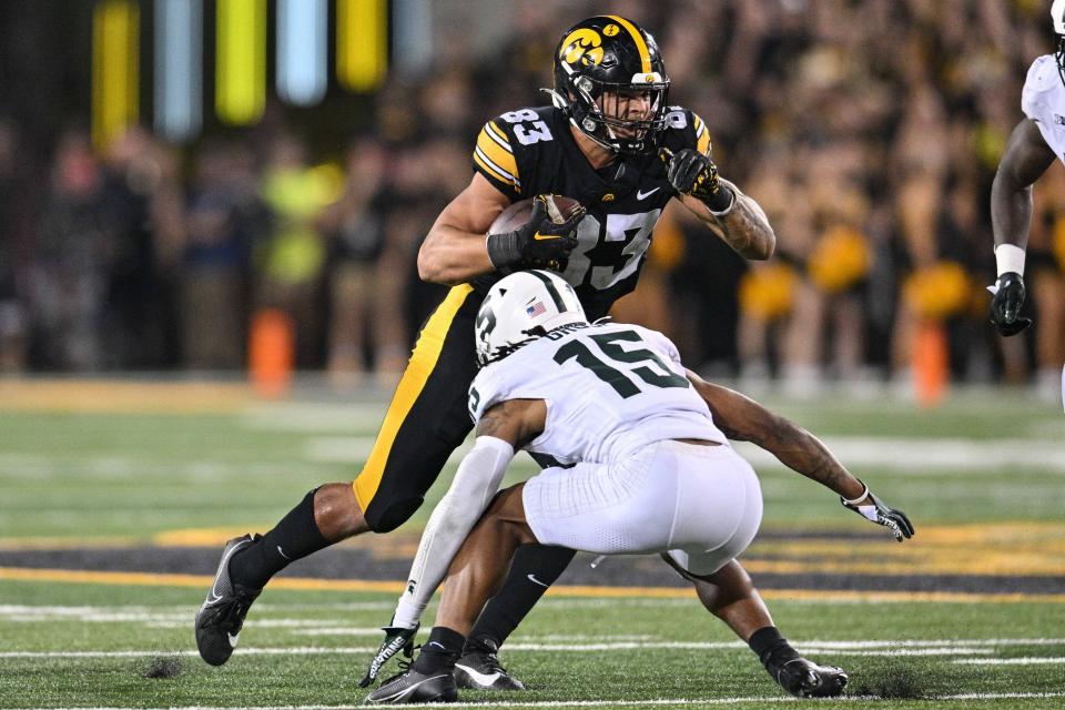 Sep 30, 2023; Iowa City, Iowa, USA; Iowa Hawkeyes tight end Erick All (83) is tackled by Michigan State Spartans defensive back Angelo Grose (15) during the fourth quarter at Kinnick Stadium. Mandatory Credit: Jeffrey Becker-USA TODAY Sports