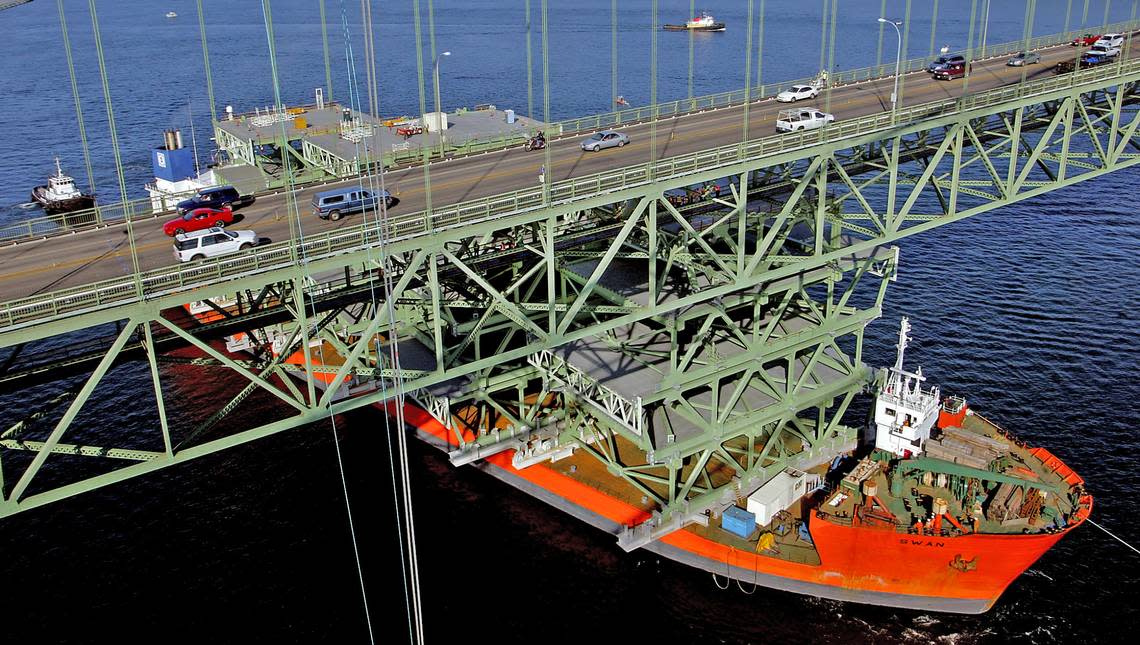 The Swan, the ship carrying the bridge deck sections for the new Tacoma Narrows Bridge, stops after temporary scaffolding on top of one of the deck sections hit the existing bridge in 2006. Dean Koepfler/The News Tribune