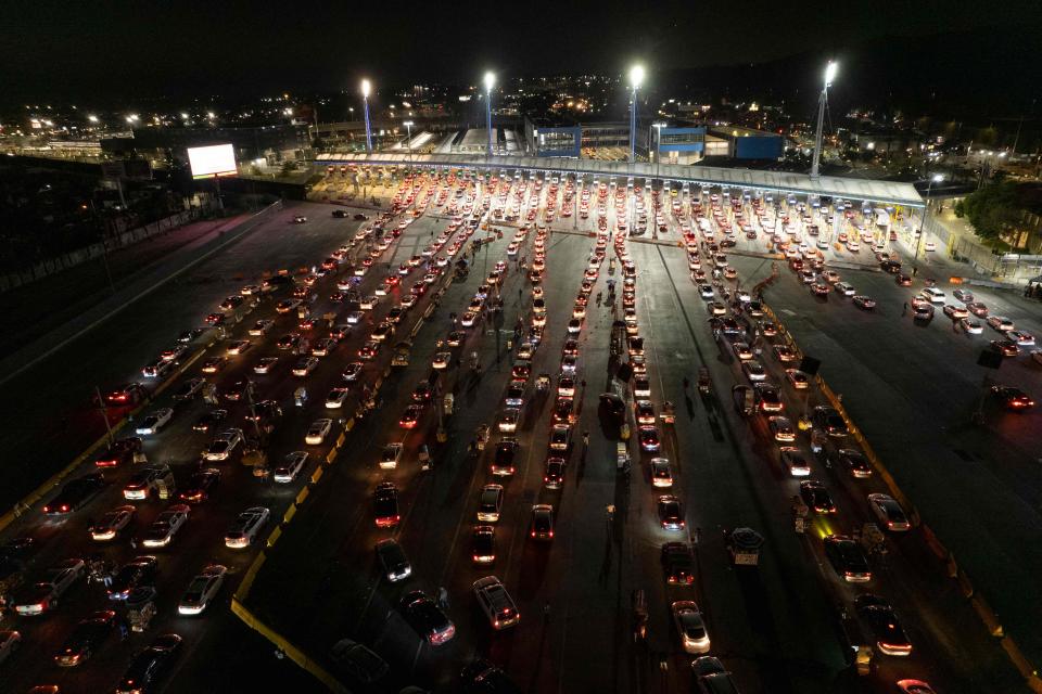 In this file photo, vehicles line up to cross the border at the San Ysidro port on the U.S.-Mexican border in Tijuana, Baja California state, Mexico, as the U.S border reopens for nonessential travel on Nov. 8, 2021.