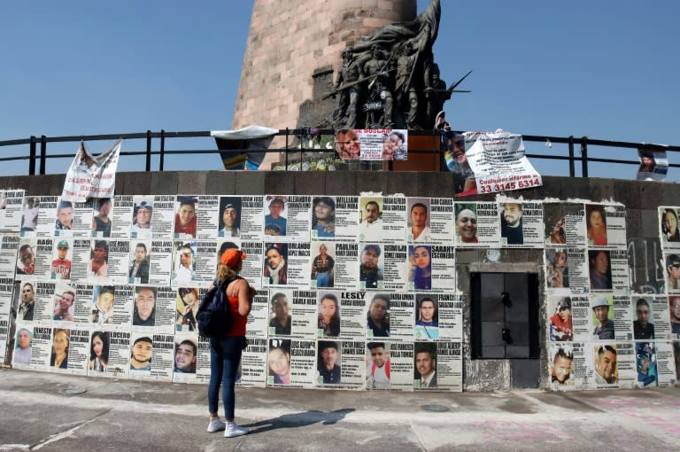 A Mexican mother looks at a wall of missing person notices in the western city of Guadalajara (AFP/ULISES RUIZ)