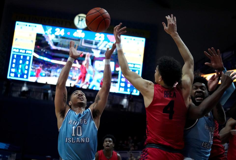 Rams guard Ishmael Leggett leaps to pull in a wild rebound during first half action. 