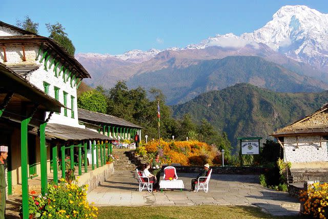 <p>Courtesy of Mountain Lodges of Nepal</p> Himalaya Lodge, a Mountain Lodges Nepal property, with the Annapurna massif in the distance.