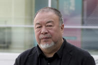 FILE - Chinese artist Ai Weiwei poses for the media during an "I am a Hong Konger! Discussing Human Rights and Democracy" panel discussion hosted by the faction of the German Liberals at the Reichstag building, home of the German federal parliament, Bundestag, in Berlin, Germany on Sept. 29, 2020. Ai is one of China's most famous artists, and many regard him as one of the world's greatest living artists. Working with the Swiss architectural firm Herzog & de Meuron, he helped design the Bird's Nest stadium, the centerpiece of Beijing's 2008 Summer Olympics. The stadium will also host the opening ceremony for Beijing's Winter Olympics on Feb. 4, 2022. (AP Photo/Michael Sohn, File)