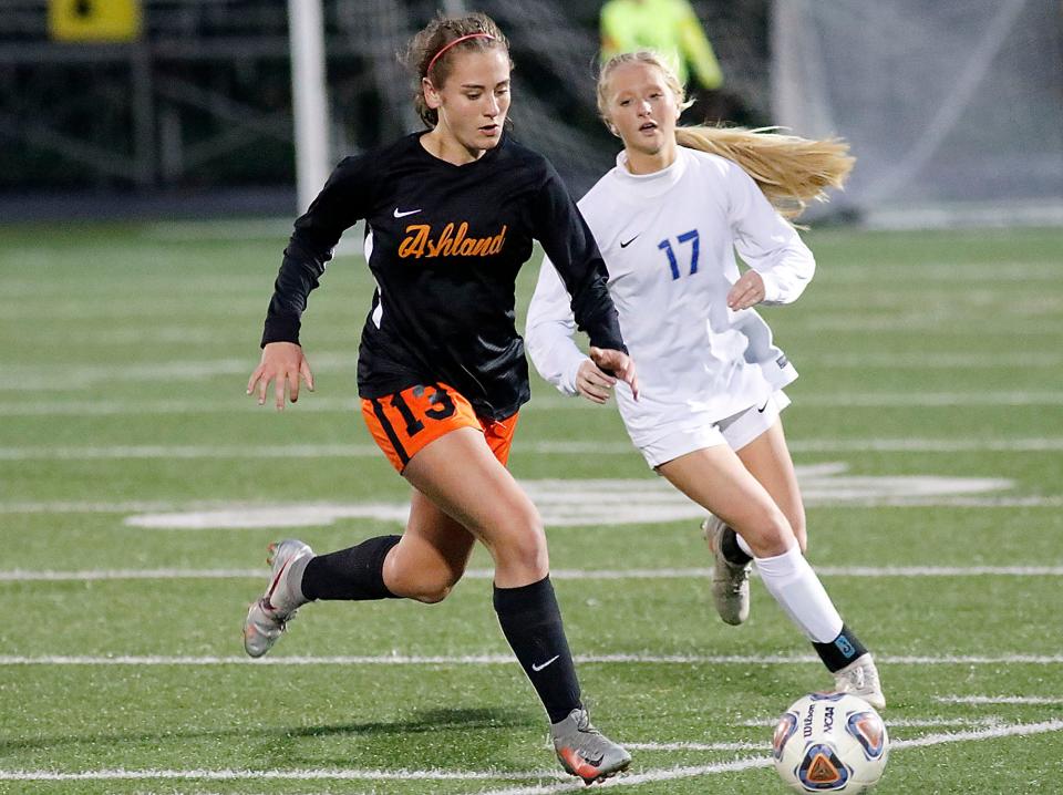 Ashland High School's Bella Dravenstott (13) brings the ball down field against Anthony Wayne High School's Payton Miller (17) during their OHSAA Division I district final soccer match on Thursday, October 28, 2021 at Sylvania Northview High School. TOM E. PUSKAR/TIMES-GAZETTE.COM