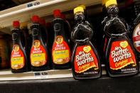 Bottles of Aunt Jemima branded syrup stand on a store shelf inside of a shop in the Brooklyn borough of New York City