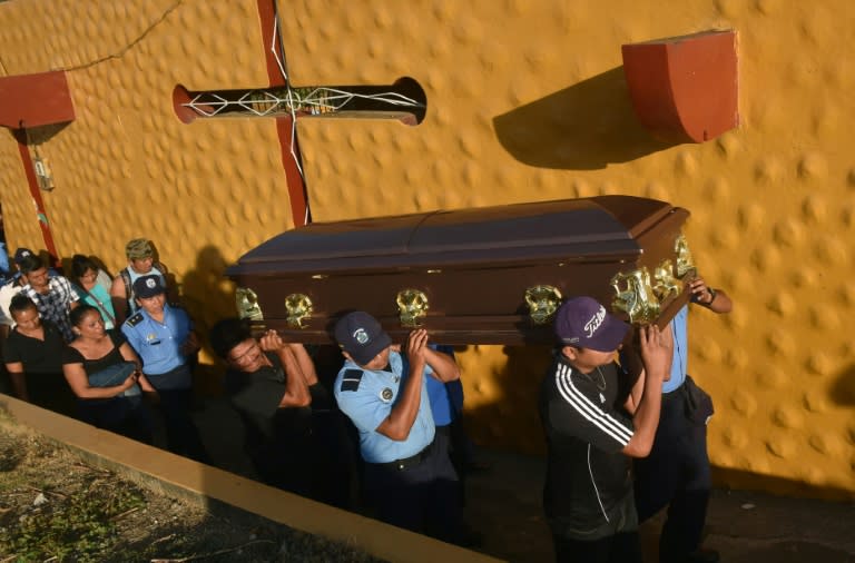 Relatives and colleagues of policewoman Juana Francisca Aguilar, who died after being injured during clashes, carry her coffin during her funeral in the city of Jinotepe on April 24, 2018