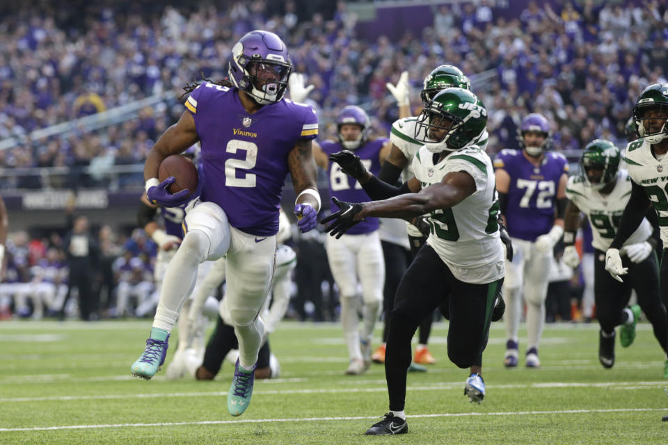 Minnesota Vikings running back Alexander Mattison (2) scores on a 14-yard touchdown run ahead of New York Jets safety Lamarcus Joyner (29) during the first half of an NFL football game, Sunday, Dec. 4, 2022, in Minneapolis. (AP Photo/Andy Clayton-King)