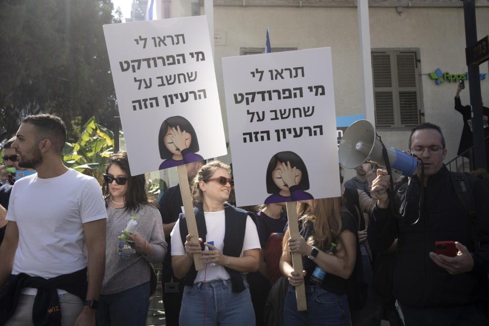 High-tech workers protest Israel's right-wing government in Tel Aviv, Tuesday, Israel, Jan. 24, 2023. Hebrew reads: "show me which product came up with this idea." As Israel's new government pushes ahead with its far-right agenda, the tech industry is speaking out in unprecedented criticism against policies it fears will drive away investors and decimate the booming sector, Israel.(AP Photo/ Maya Alleruzzo)