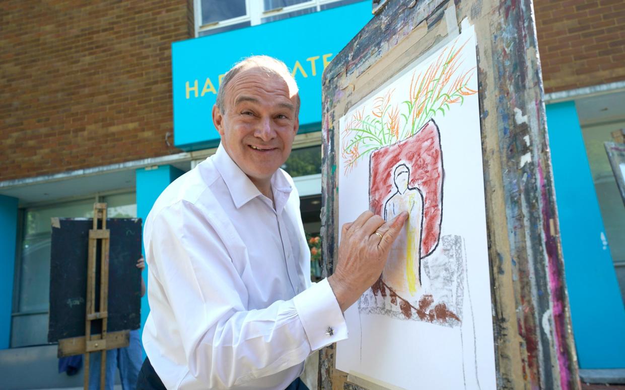 Sir Ed Davey, the leader of the Liberal Democrats, tries his hand at drawing during a visit to Harrogate College in Yorkshire