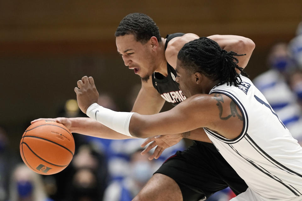 Duke guard Trevor Keels (1) guards North Carolina State forward Jericole Hellems as he dribbles during the first half of an NCAA college basketball game in Durham, N.C., Saturday, Jan. 15, 2022. (AP Photo/Gerry Broome)